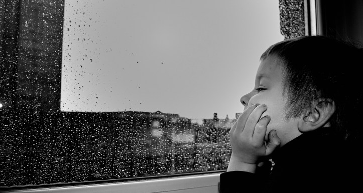 Canva - Child Watching the Rain by the Window